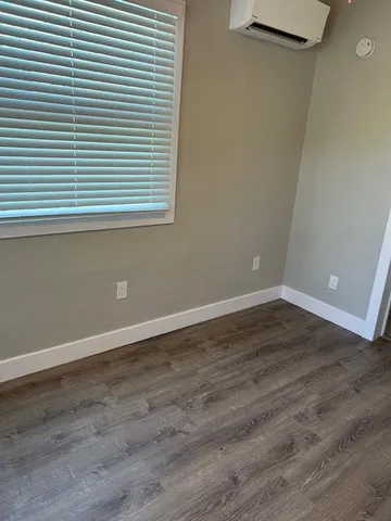 an empty room with wooden floor