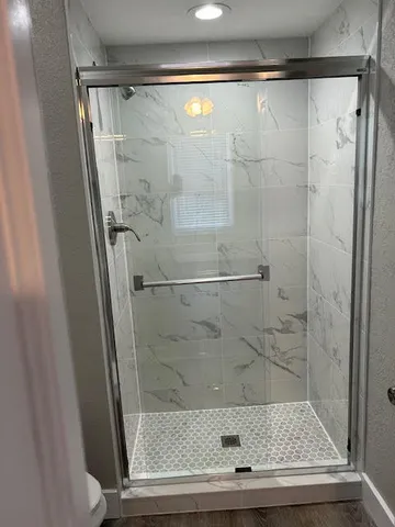 a bathroom with a shower and a sink