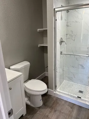a white toilet sitting next to a bathroom sink