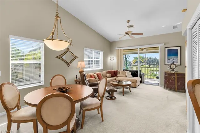 a living room with furniture a window and a chandelier