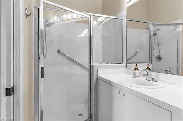 a bathroom with a shower sink and mirror