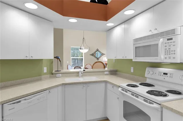 a kitchen with a sink a stove and cabinets