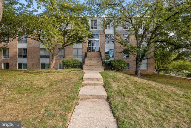 a front view of a building with a yard