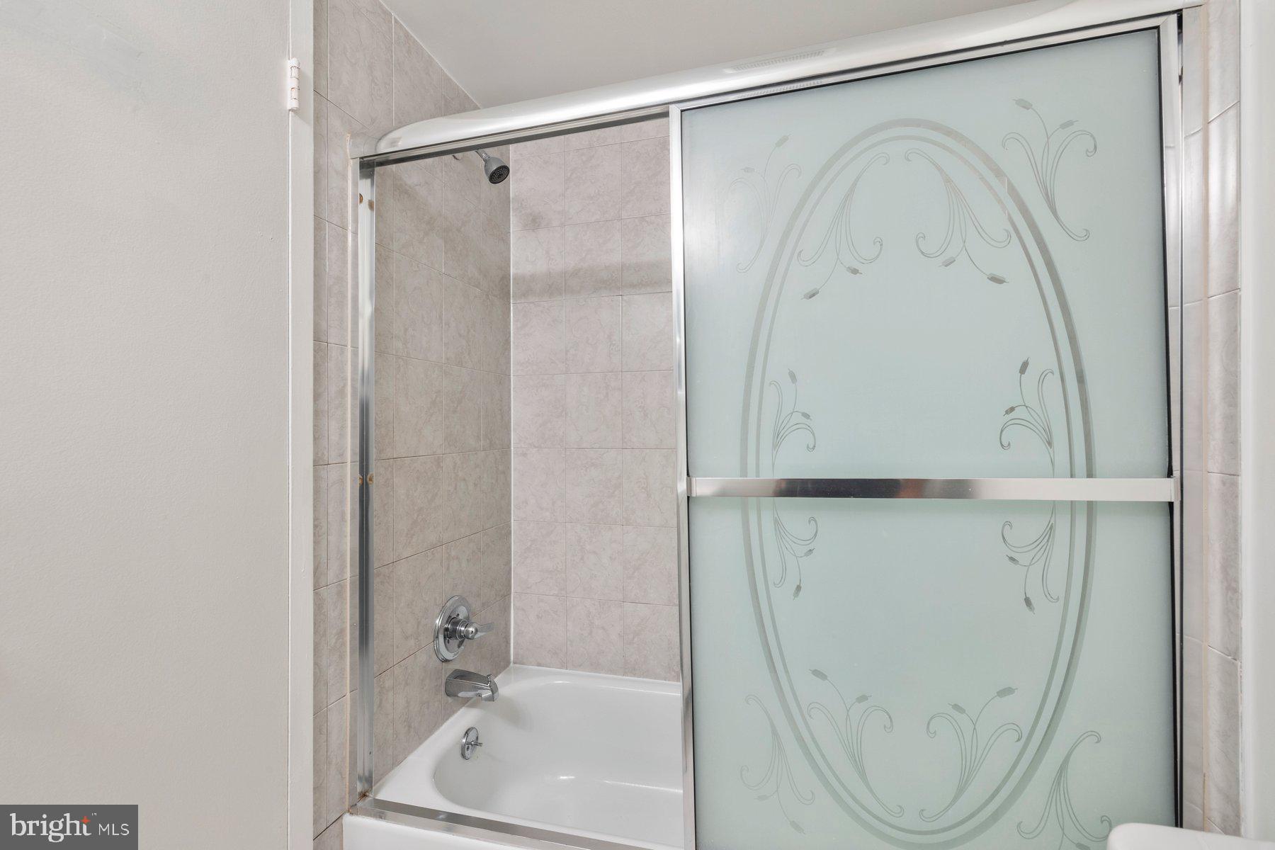3946 Bel Pre Road, Unit 39466 Silver Spring, MD 20906 - Photo 15 of 27 a bathroom with a shower and a bath tub