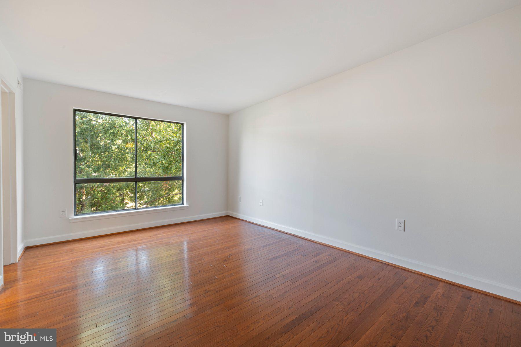 3946 Bel Pre Road, Unit 39466 Silver Spring, MD 20906 - Photo 19 of 27 a view of a big room with wooden floor and windows