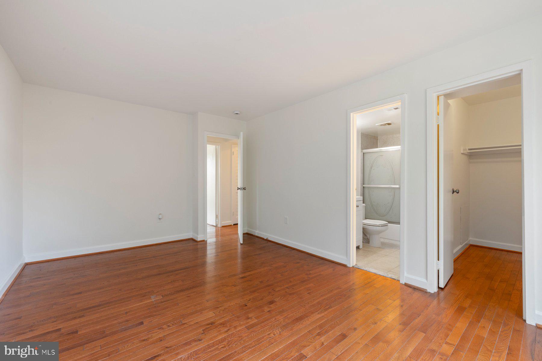 3946 Bel Pre Road, Unit 39466 Silver Spring, MD 20906 - Photo 21 of 27 a view of an empty room with wooden floor and a bathroom