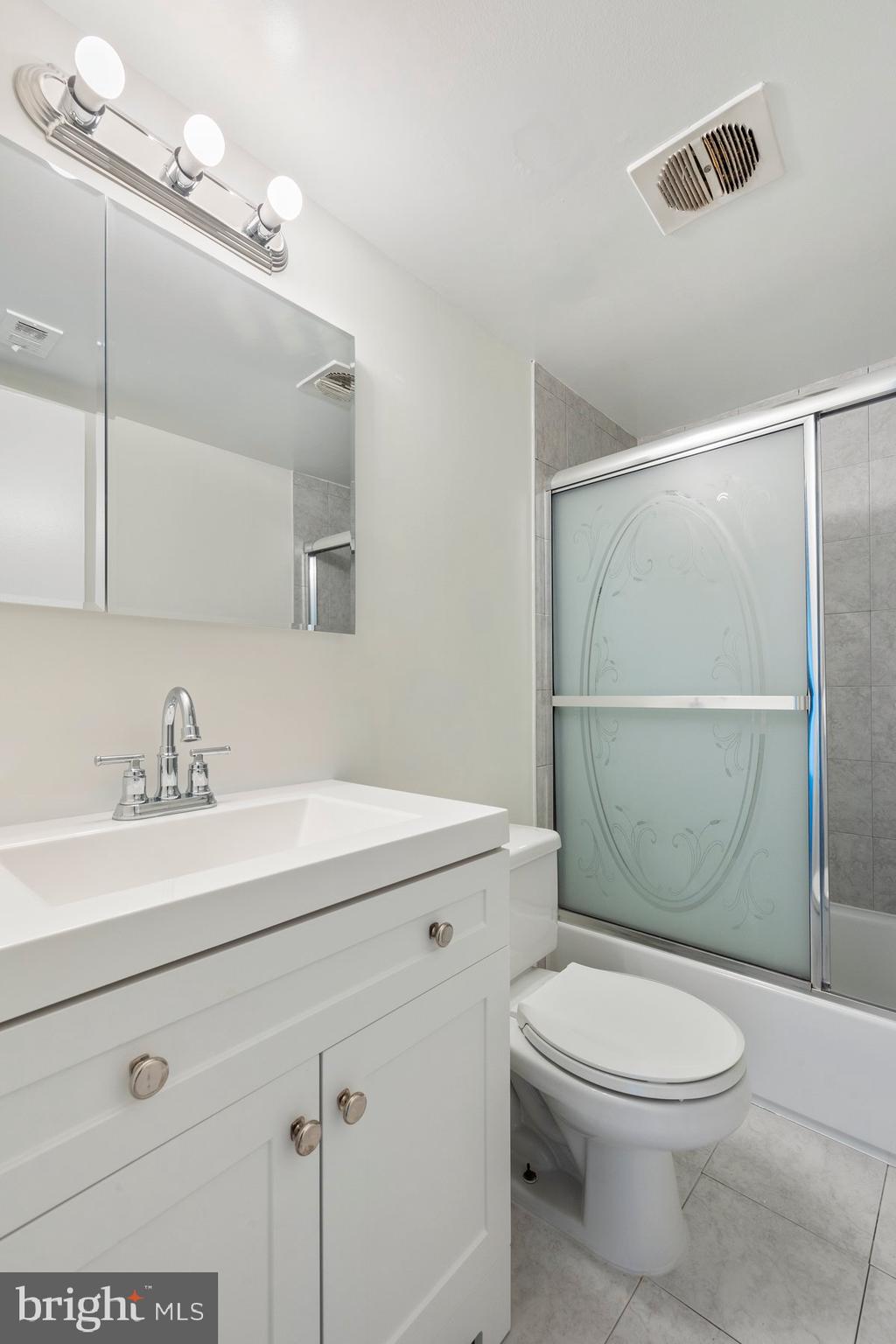 3946 Bel Pre Road, Unit 39466 Silver Spring, MD 20906 - Photo 24 of 27 a bathroom with a sink a toilet and shower