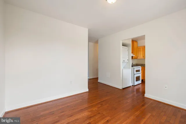 an empty room with wooden floor and closet