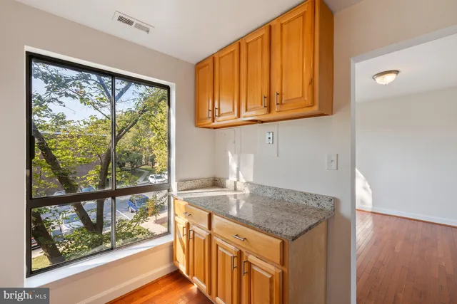 a kitchen that has a sink and a wooden floor