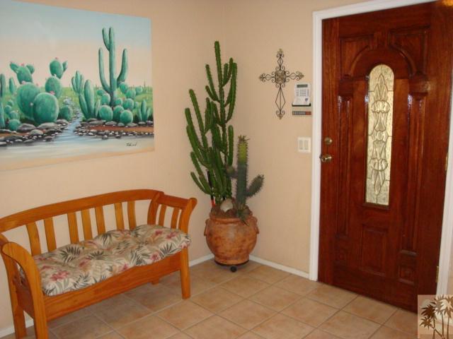 68205 Encinitas Road Cathedral City, CA 92234 - Photo 2 of 8 a view of a porch with furniture and a potted plant