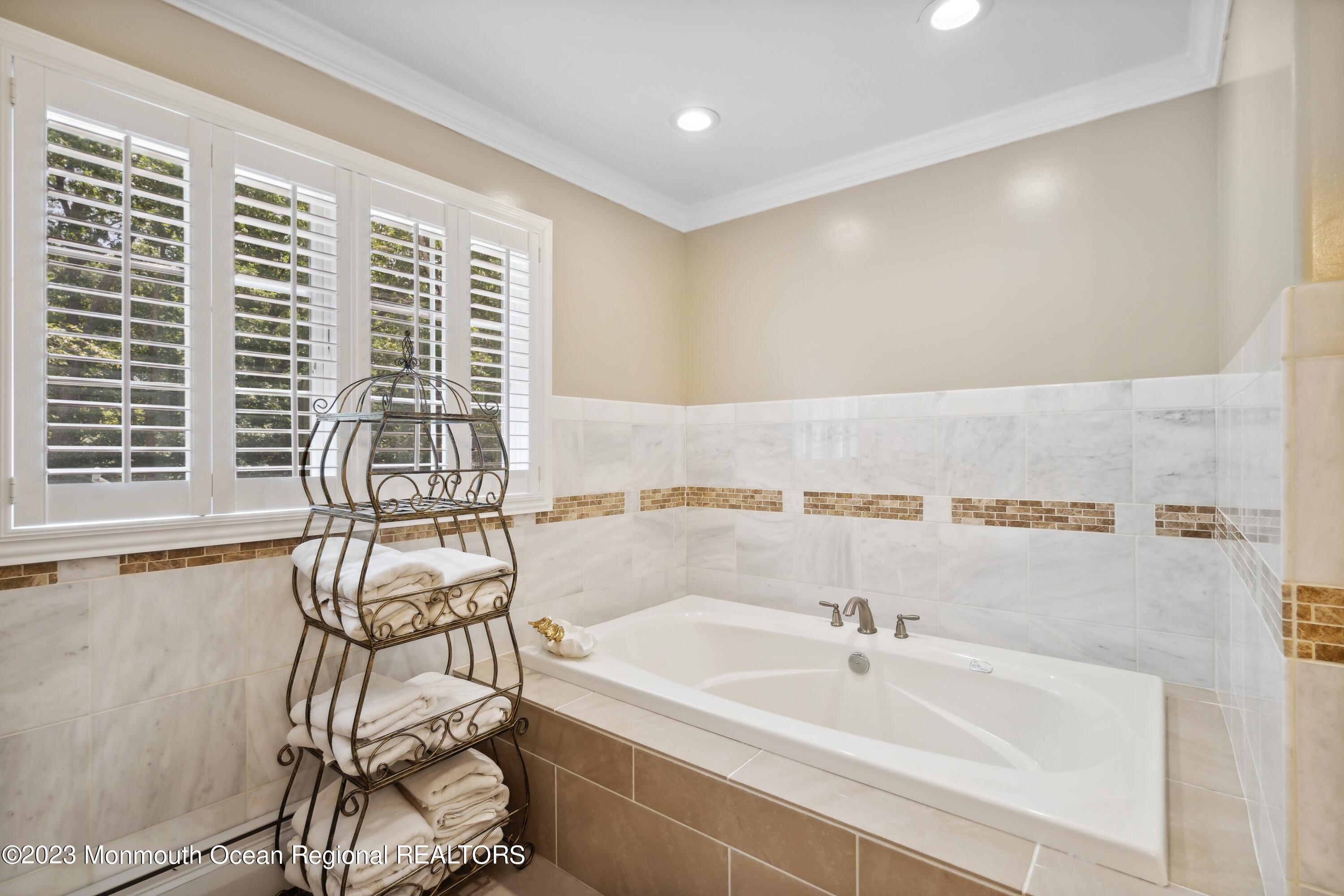 70 Bates Road Jackson, NJ 08527 - Photo 18 of 33 a bathroom with a bathtub and next to a window
