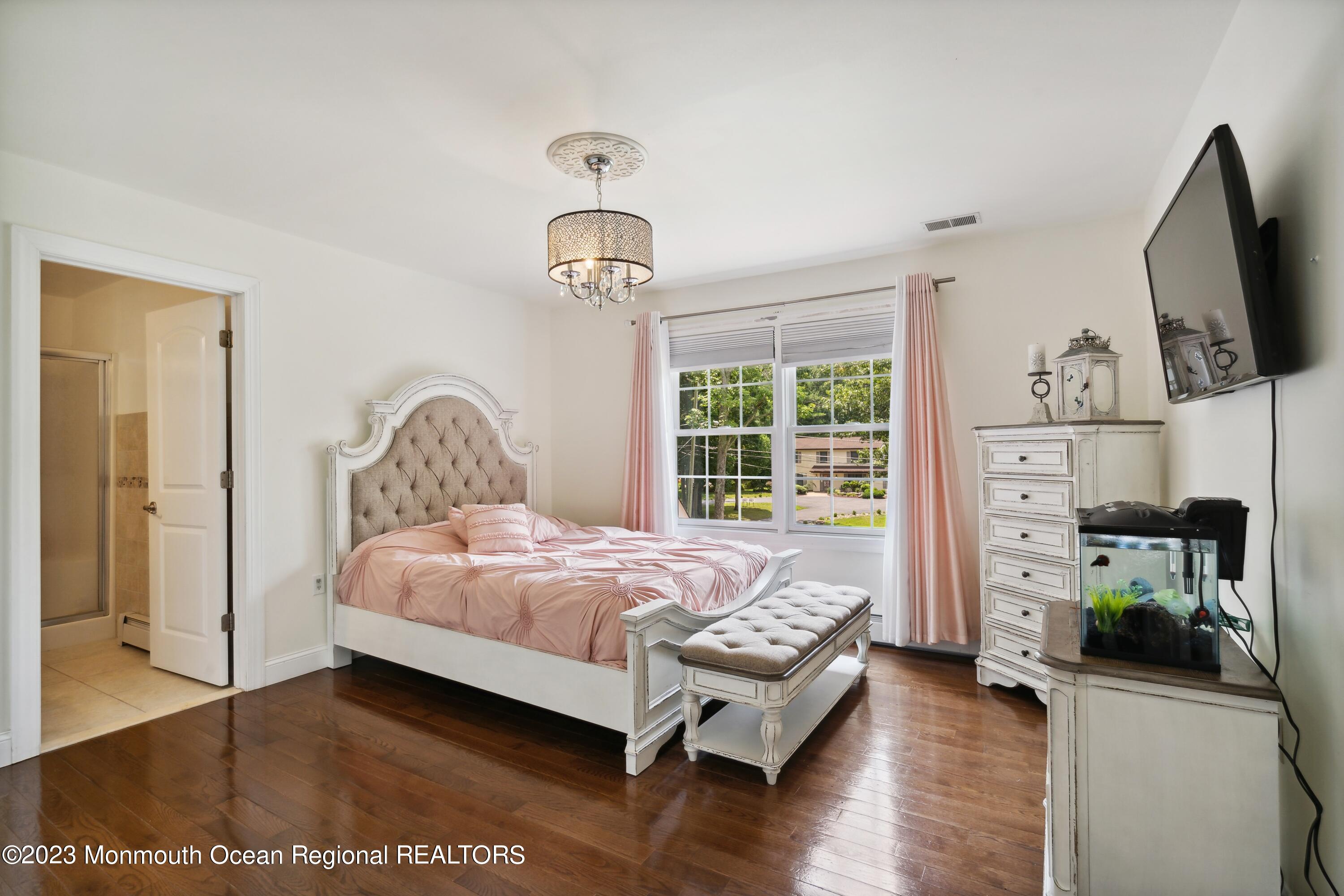 70 Bates Road Jackson, NJ 08527 - Photo 20 of 33 a bedroom with a bed a flat screen tv and dresser