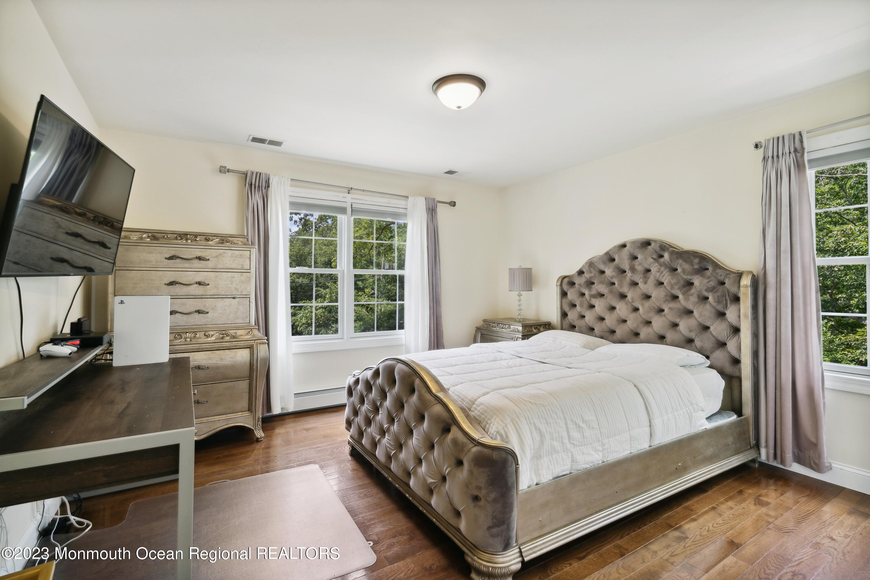 70 Bates Road Jackson, NJ 08527 - Photo 23 of 33 a bedroom with a bed and a flat tv screen on the dresser