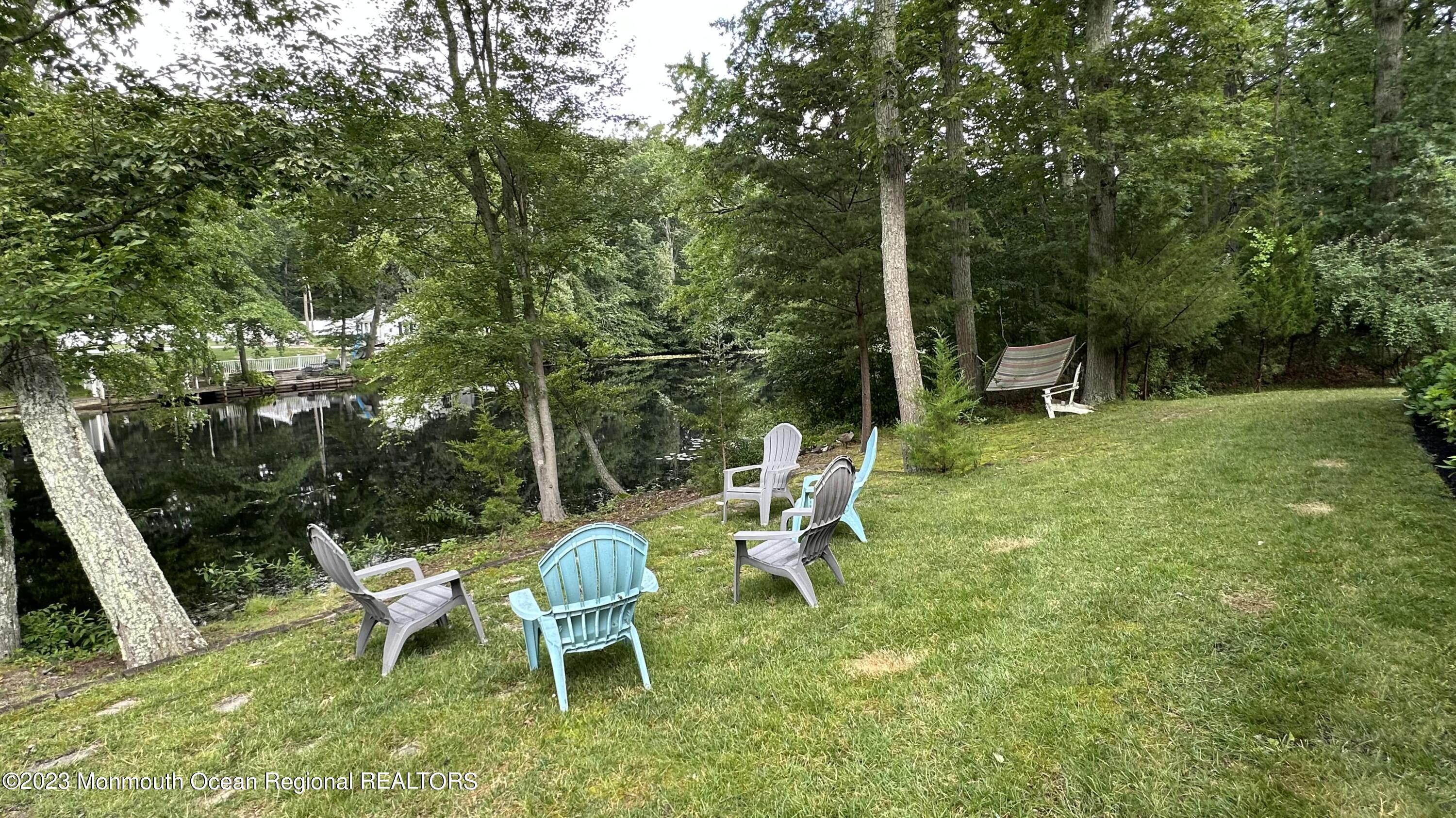 70 Bates Road Jackson, NJ 08527 - Photo 28 of 33 a view of backyard with table and chairs and wooden fence