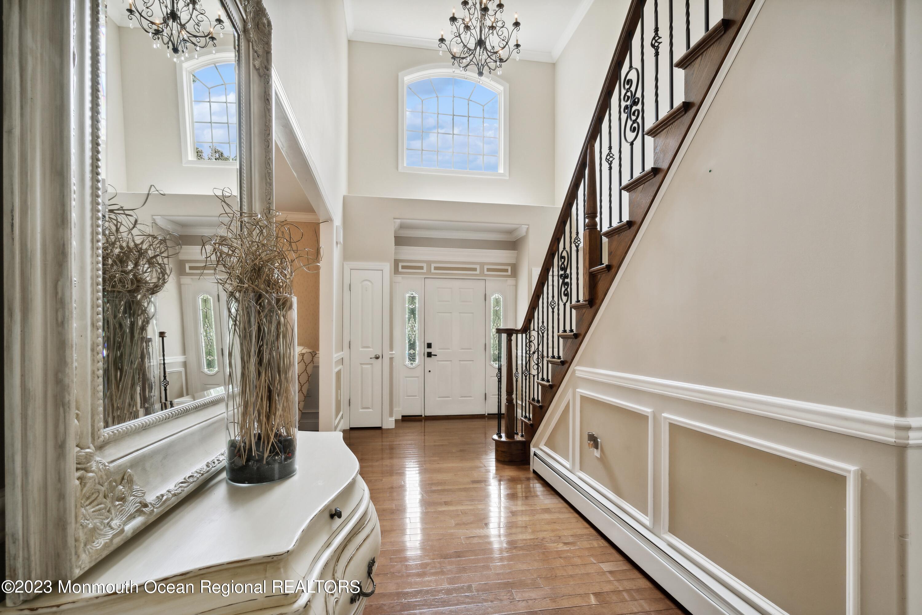 70 Bates Road Jackson, NJ 08527 - Photo 31 of 33 a living room with a balcony a bed and a large window with wooden floor