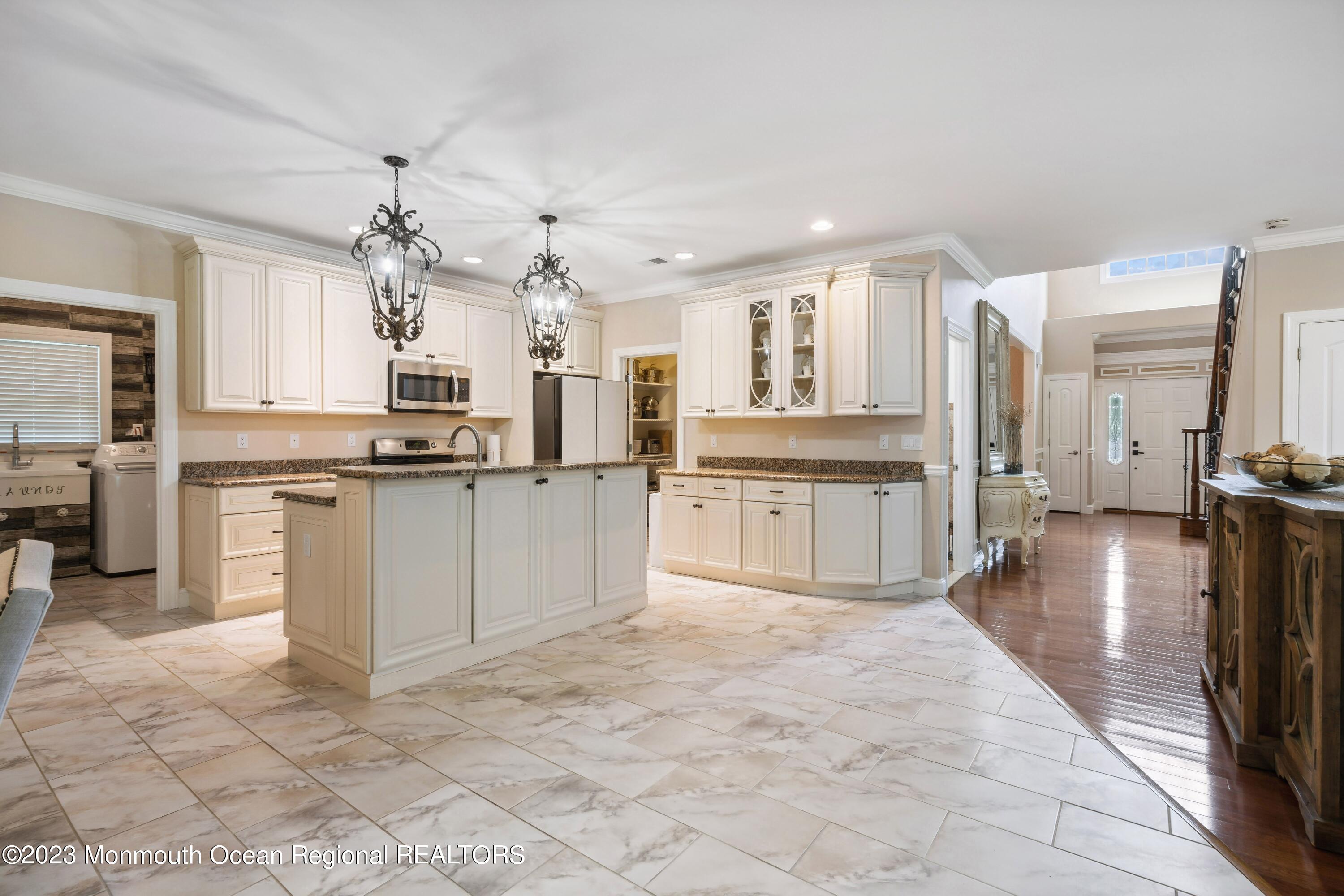 70 Bates Road Jackson, NJ 08527 - Photo 33 of 33 a large white kitchen with cabinets and stainless steel appliances