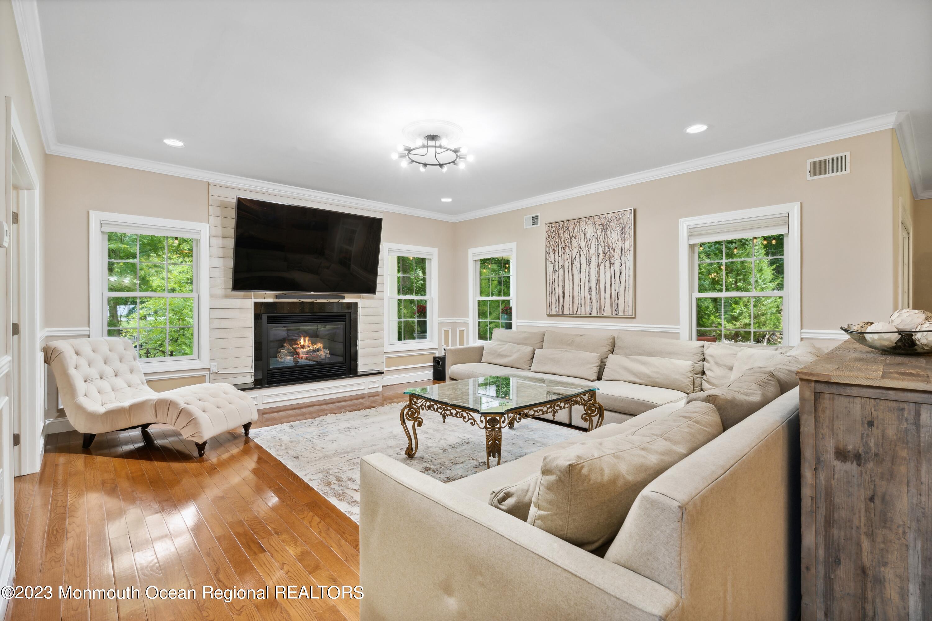 70 Bates Road Jackson, NJ 08527 - Photo 9 of 33 a living room with furniture a fireplace and a flat screen tv
