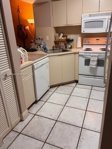 a kitchen with a stove top oven and cabinets