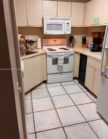 a view of an entryway with wooden floor and a rug