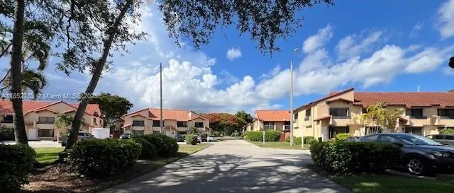 a view of a street with a building in the background