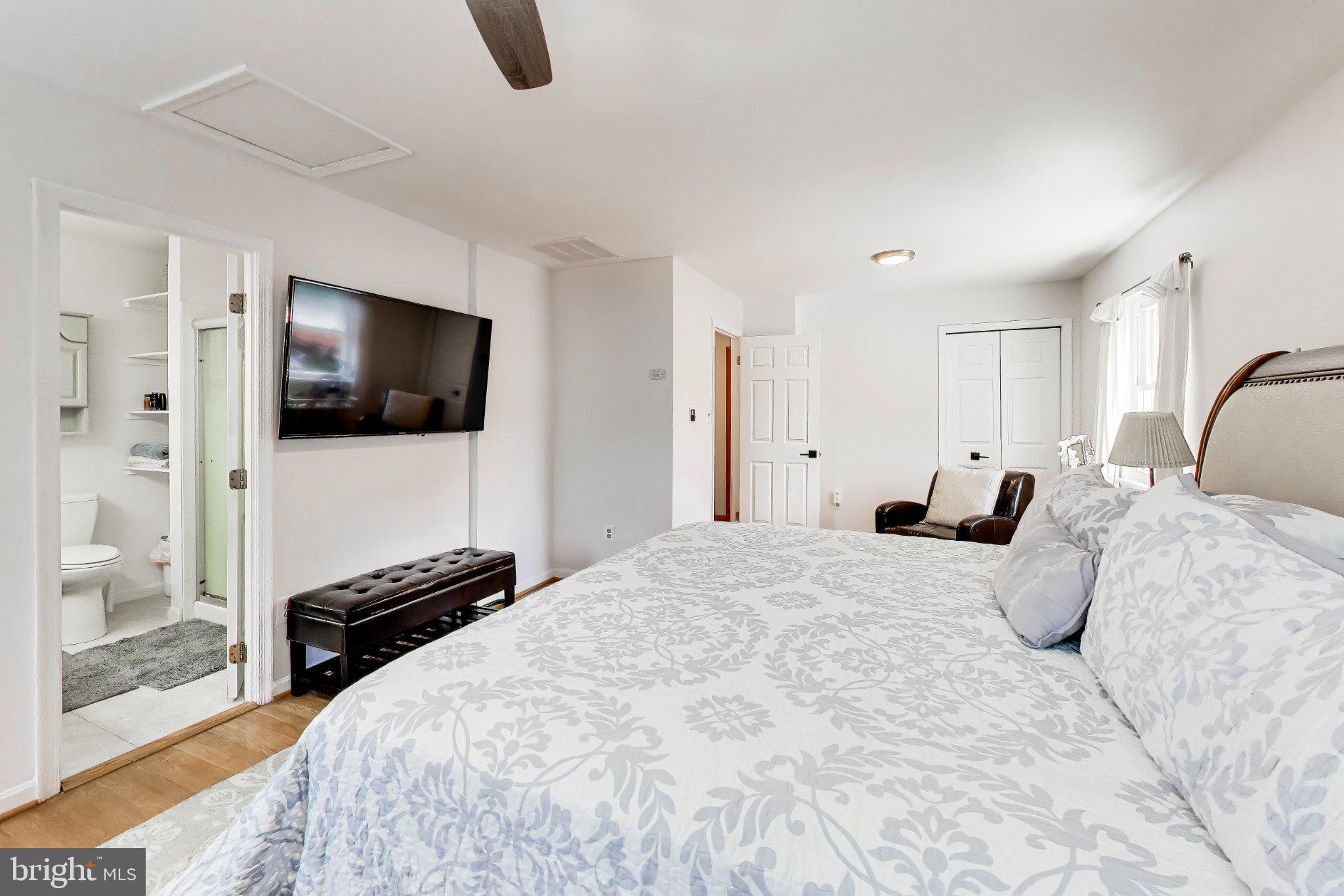 14216 Alderton Road Silver Spring, MD 20906 - Photo 23 of 63 a bedroom with a bed a television and wooden floor