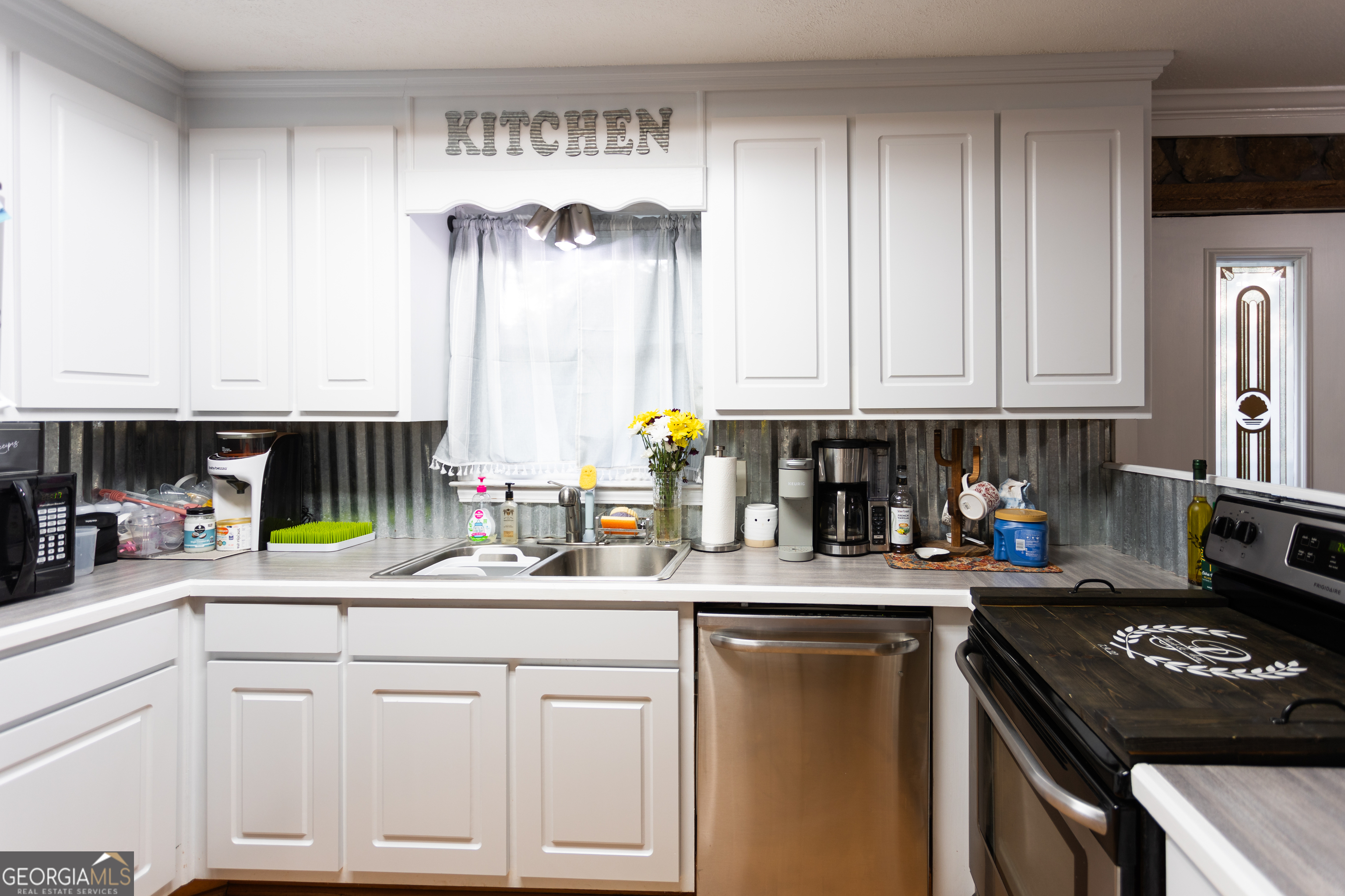 1585 Flat Rock Road Covington, GA 30014 - Photo 14 of 48 a kitchen with a sink stove and cabinets