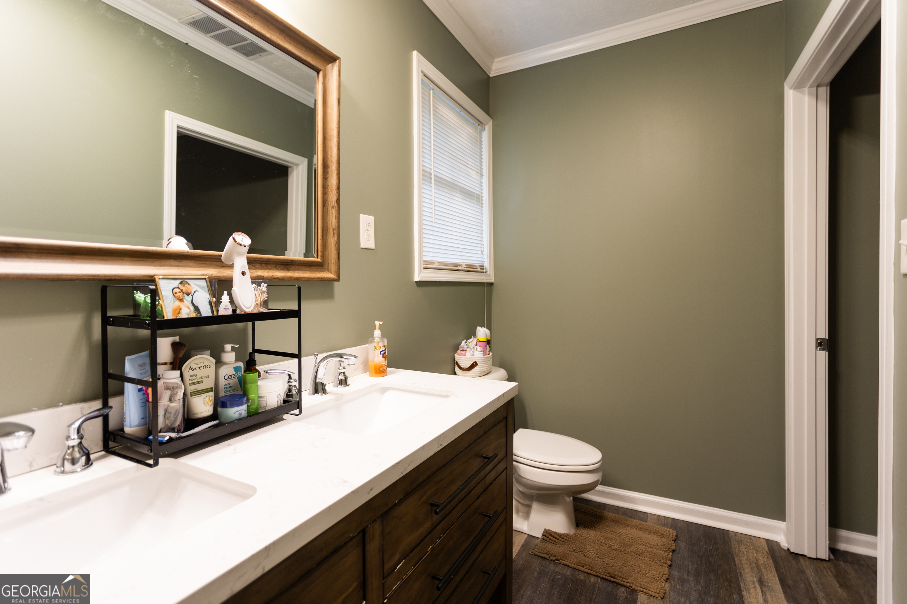 1585 Flat Rock Road Covington, GA 30014 - Photo 19 of 48 a bathroom with a sink a toilet and mirror