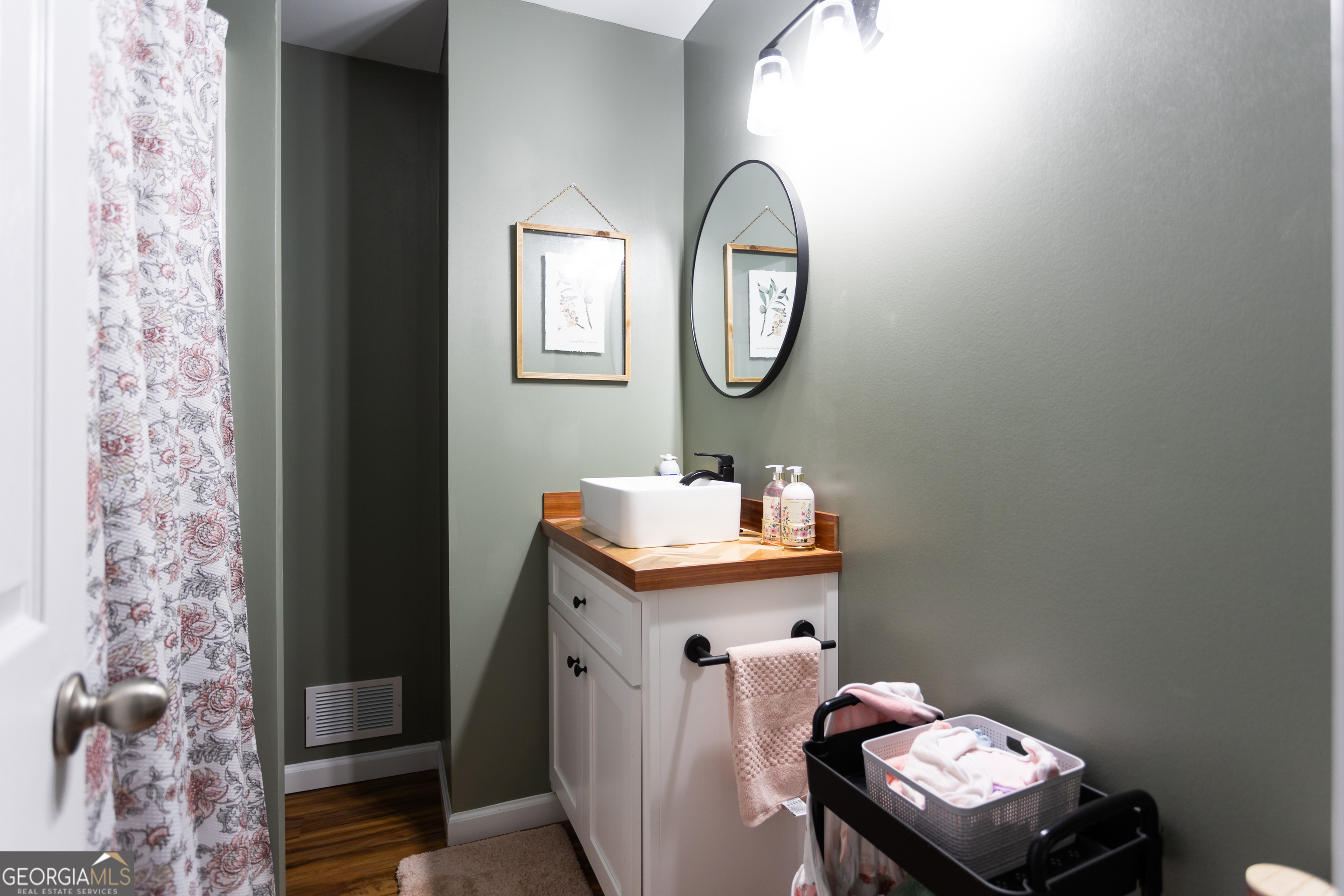 1585 Flat Rock Road Covington, GA 30014 - Photo 25 of 48 a bathroom with a toilet a sink and mirror