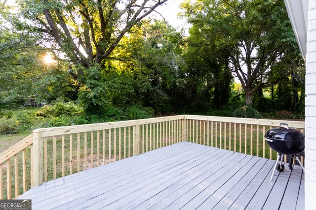 a view of a deck with wooden floor and fence