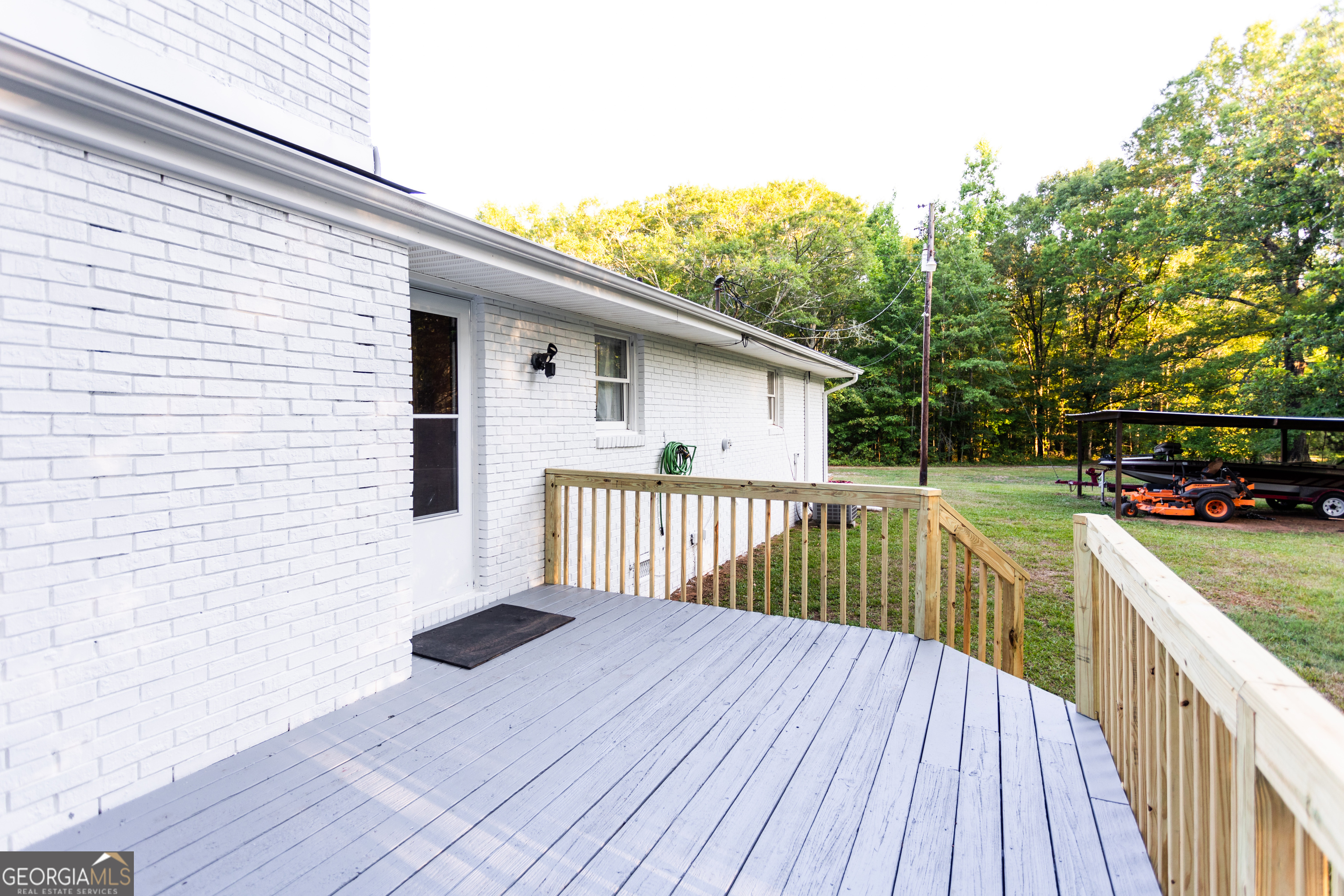 1585 Flat Rock Road Covington, GA 30014 - Photo 32 of 48 a view of a deck with wooden floor and fence