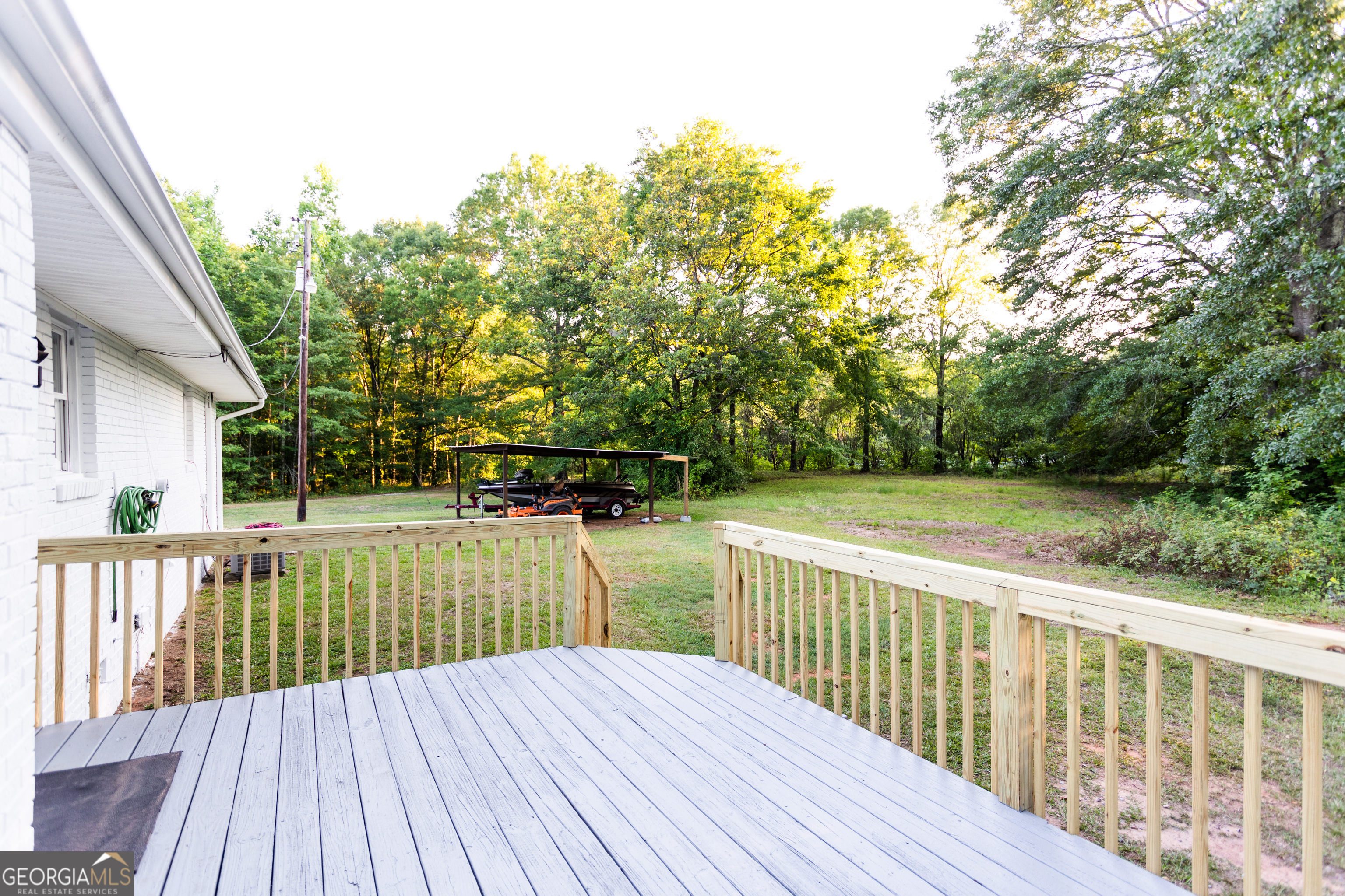 1585 Flat Rock Road Covington, GA 30014 - Photo 33 of 48 a view of deck with wooden floor and fence next to a yard