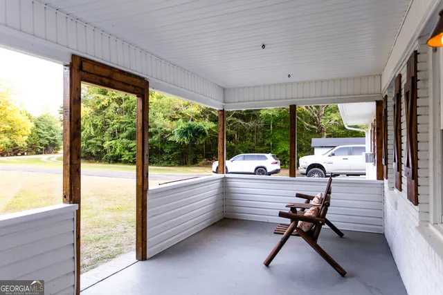 a backyard of a house with barbeque oven table and chairs