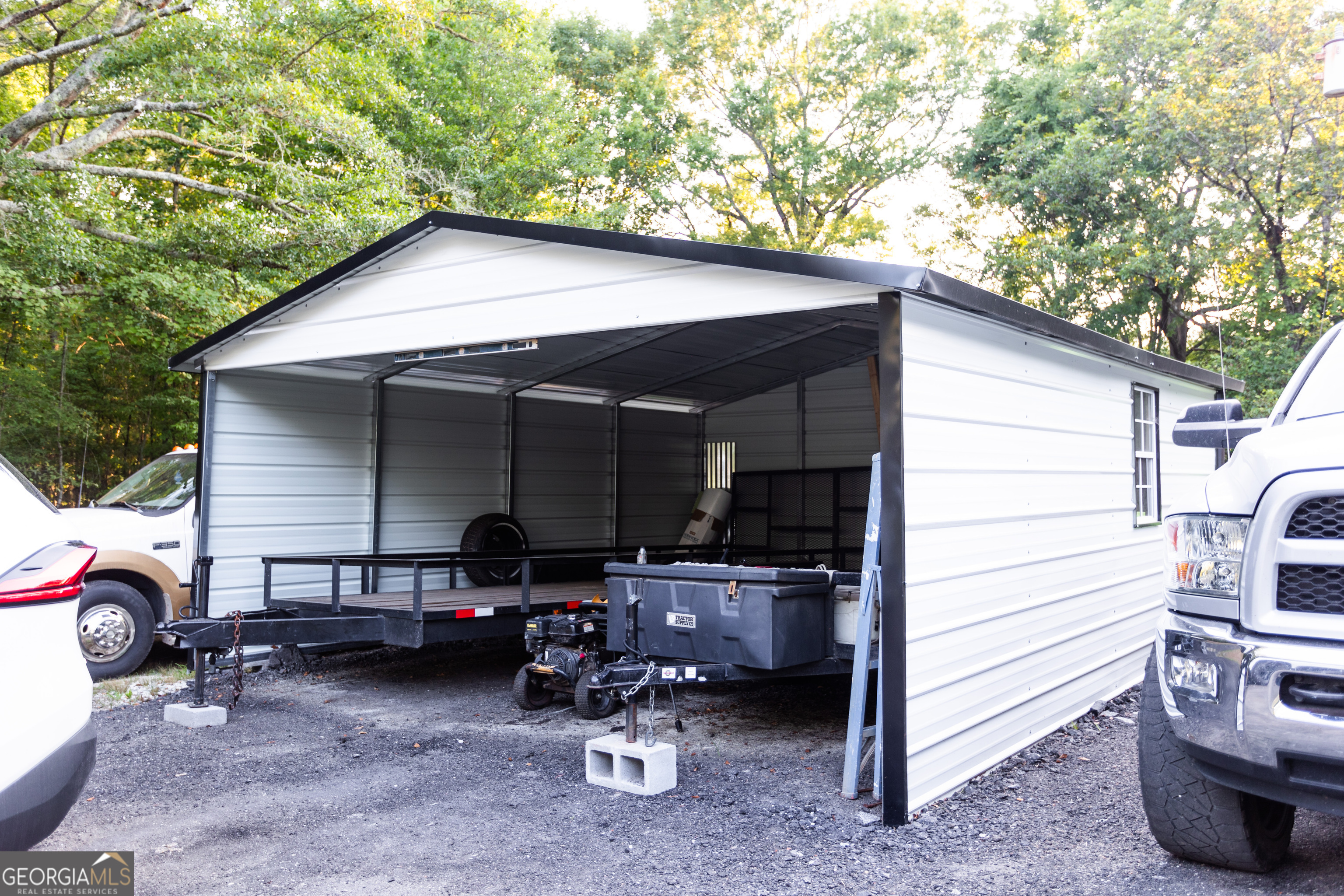 1585 Flat Rock Road Covington, GA 30014 - Photo 40 of 48 a backyard of a house with barbeque oven table and chairs
