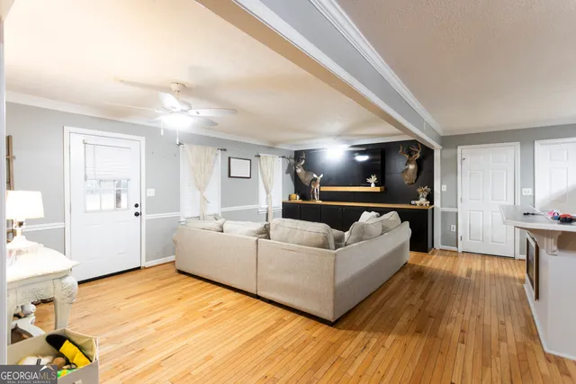a living room with furniture and a flat screen tv
