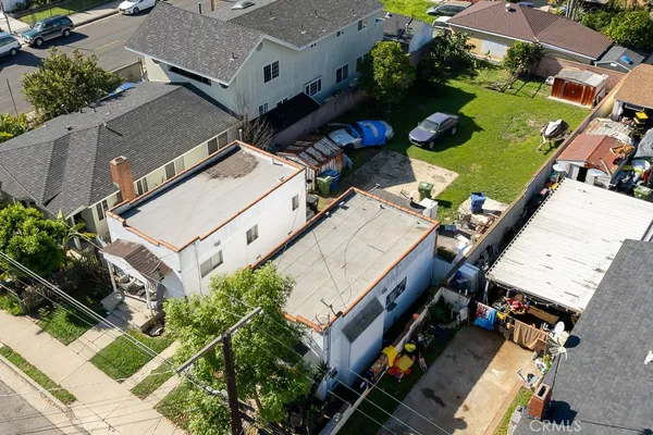 an aerial view of a house with a yard and outdoor seating