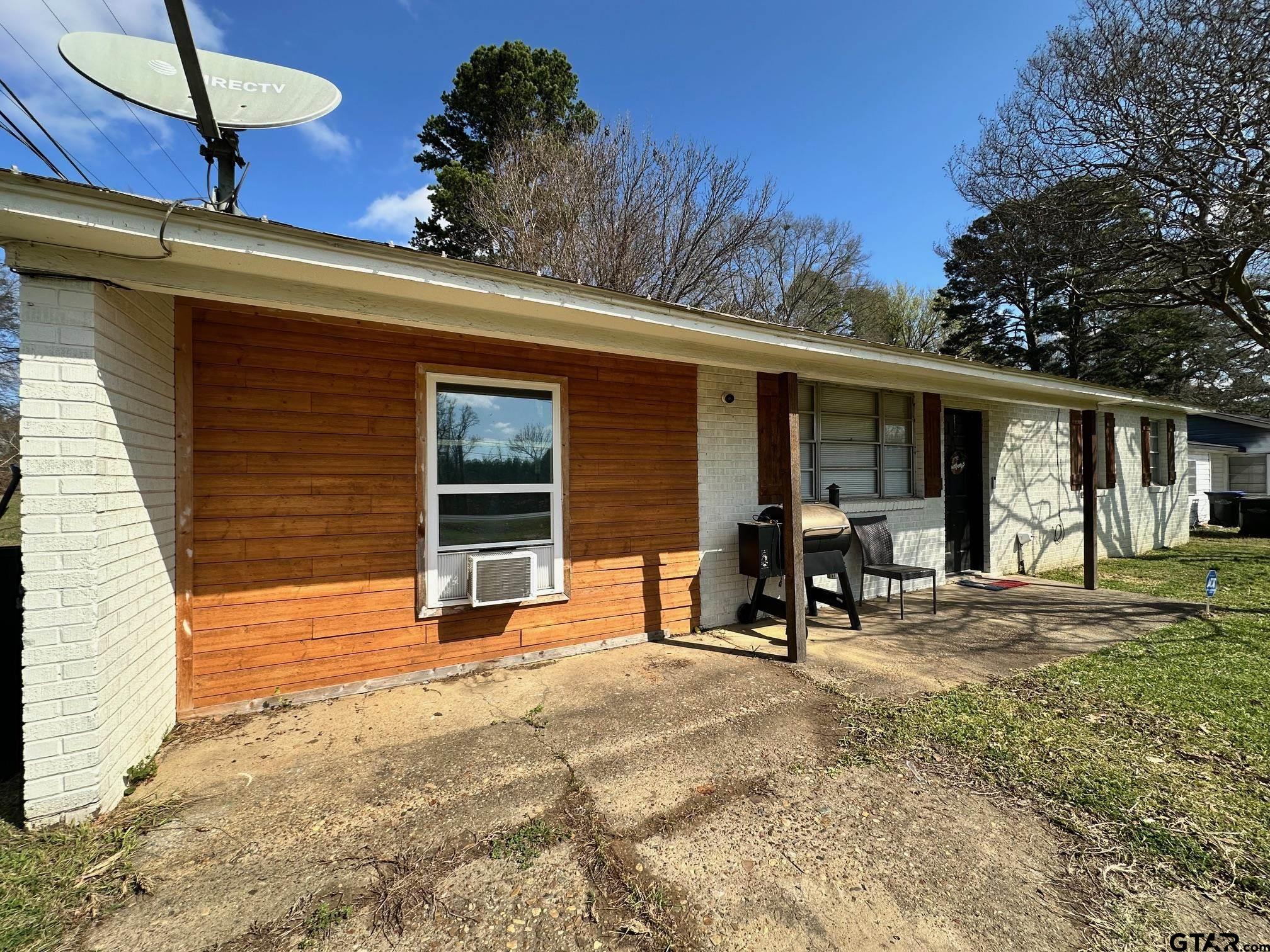 2601 East George Richey Road Longview, TX 75604 - Photo 2 of 26 a view of a house with backyard porch and sitting area