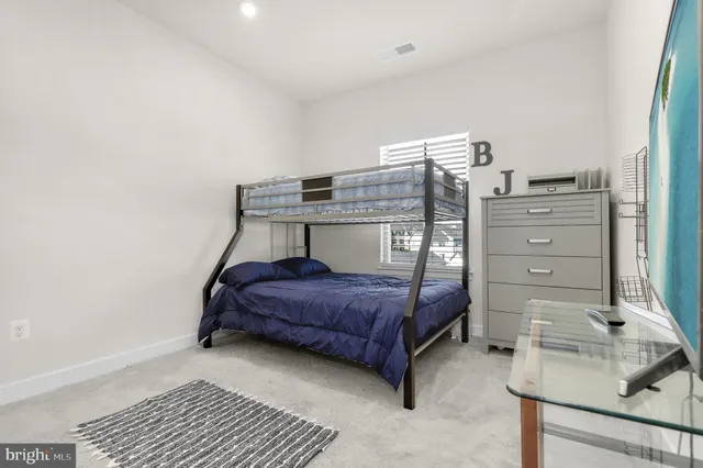 a bedroom with a bed and cabinets