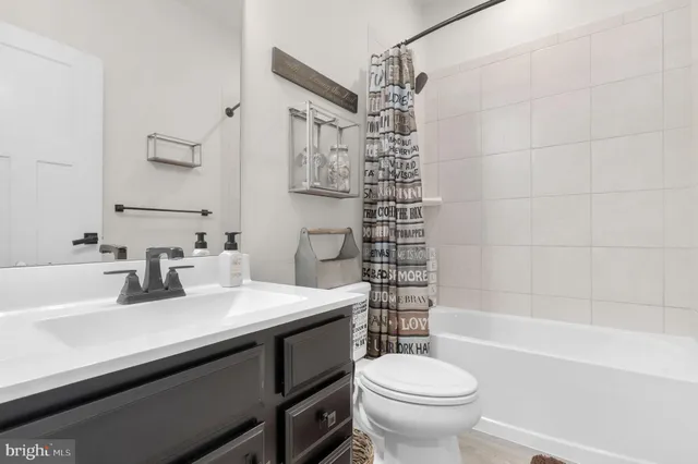 a bathroom with a sink toilet vanity and shower