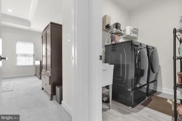 a view of a hallway with closet and utility room