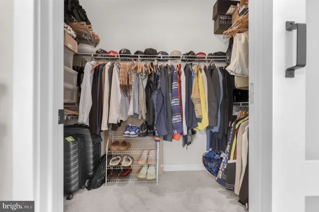 a view of walk in closet with clothes