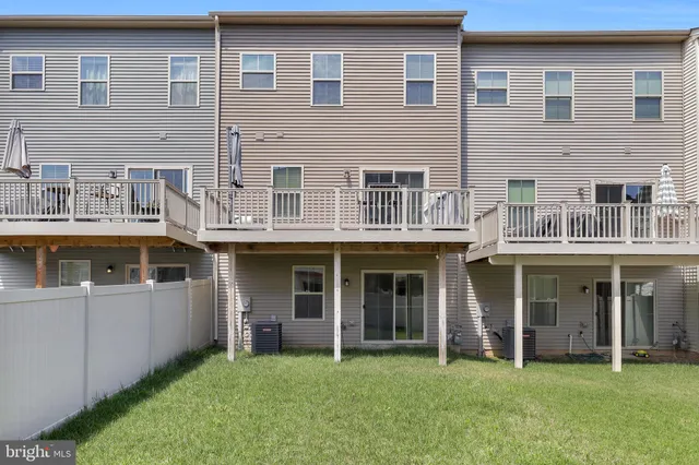 a front view of a building with a garden