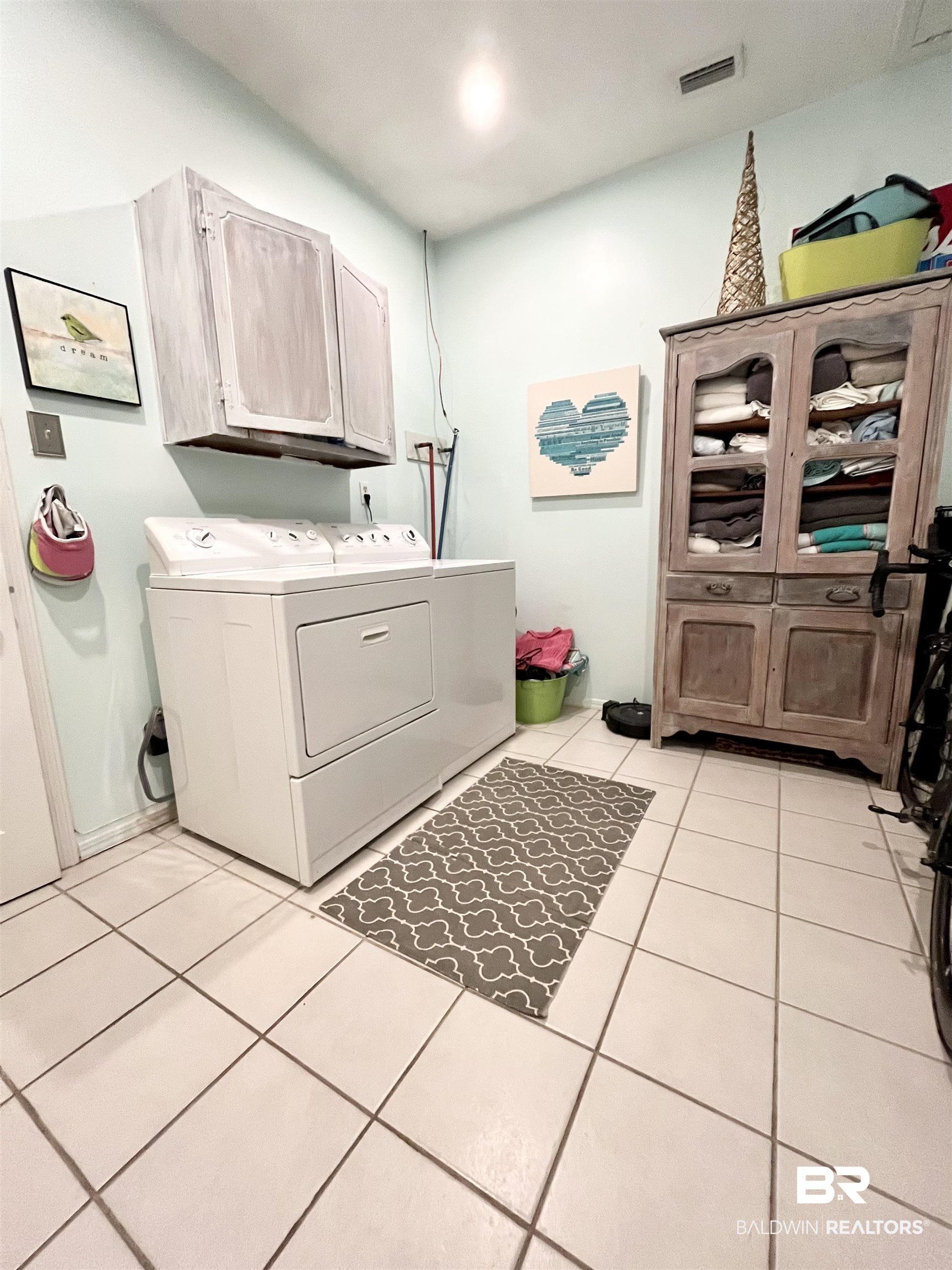 451 Ridgelawn Drive West Mobile, AL 36608 - Photo 25 of 41 Clothes washing area featuring cabinet space, separate washer and dryer, and light tile patterned floors