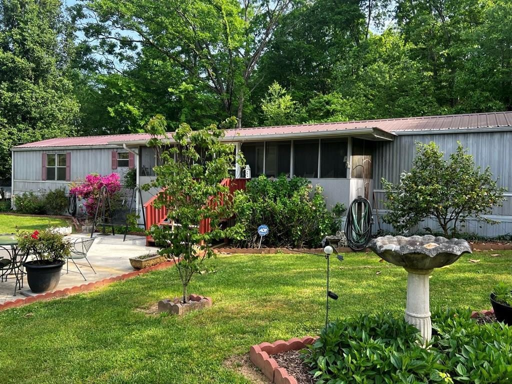 106 Pin Hook Road Spring City, TN 37381 - Photo 2 of 37 a view of a house with backyard sitting area and garden