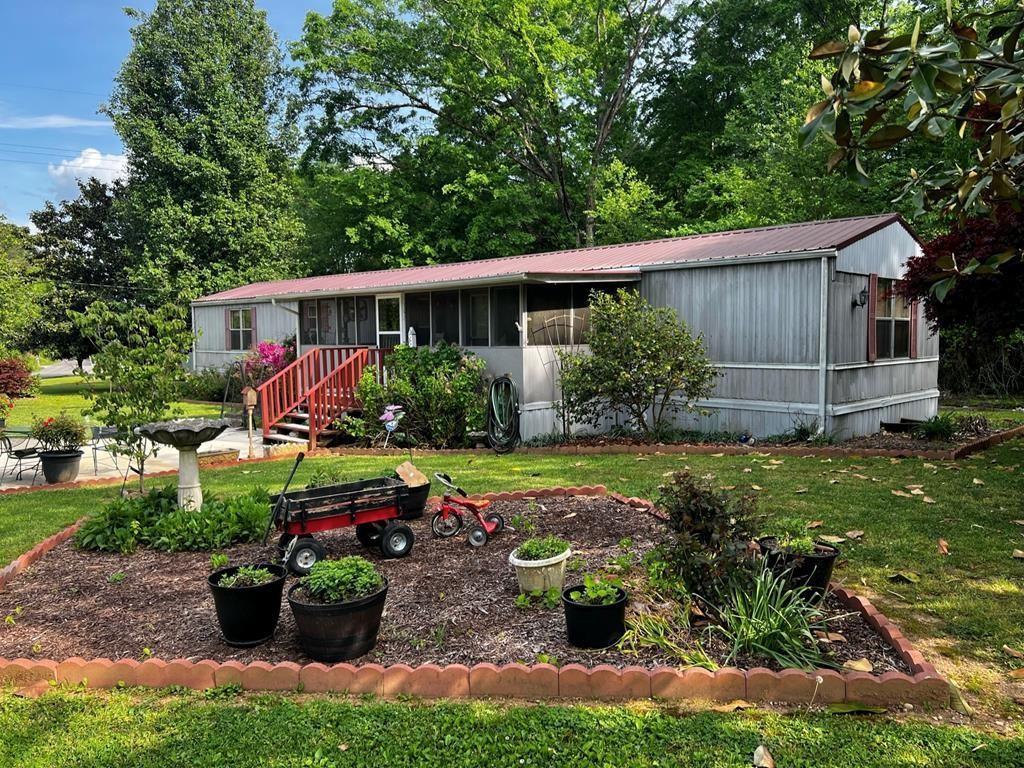 106 Pin Hook Road Spring City, TN 37381 - Photo 3 of 37 a view of a backyard with garden and patio