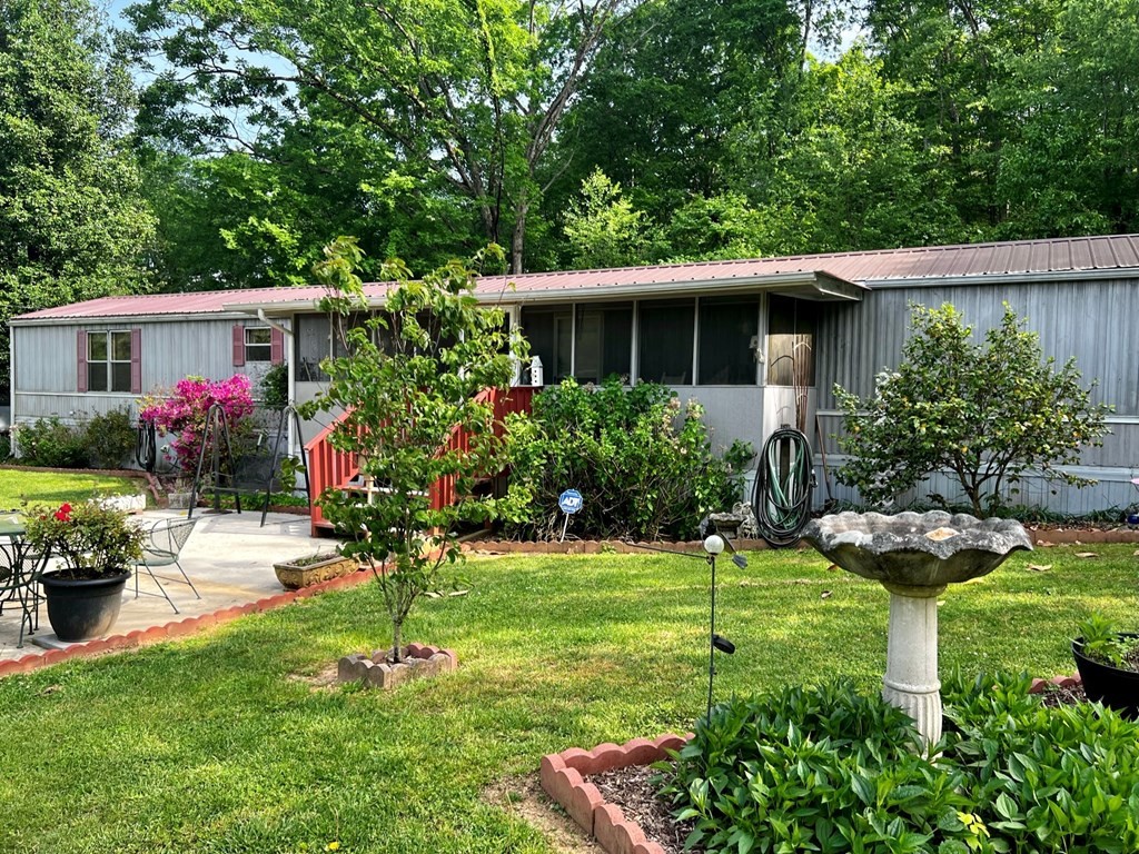 106 Pin Hook Road Spring City, TN 37381 - Photo 37 of 37 a view of a house with backyard sitting area and garden