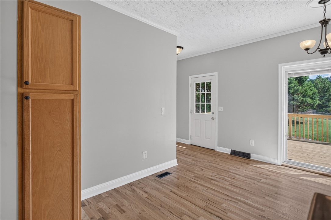 564 Fairfield Road Walhalla, SC 29691 - Photo 13 of 50 Gleaming hardwood floors and classic crown molding accent this versatile transition space near the deck entrance.