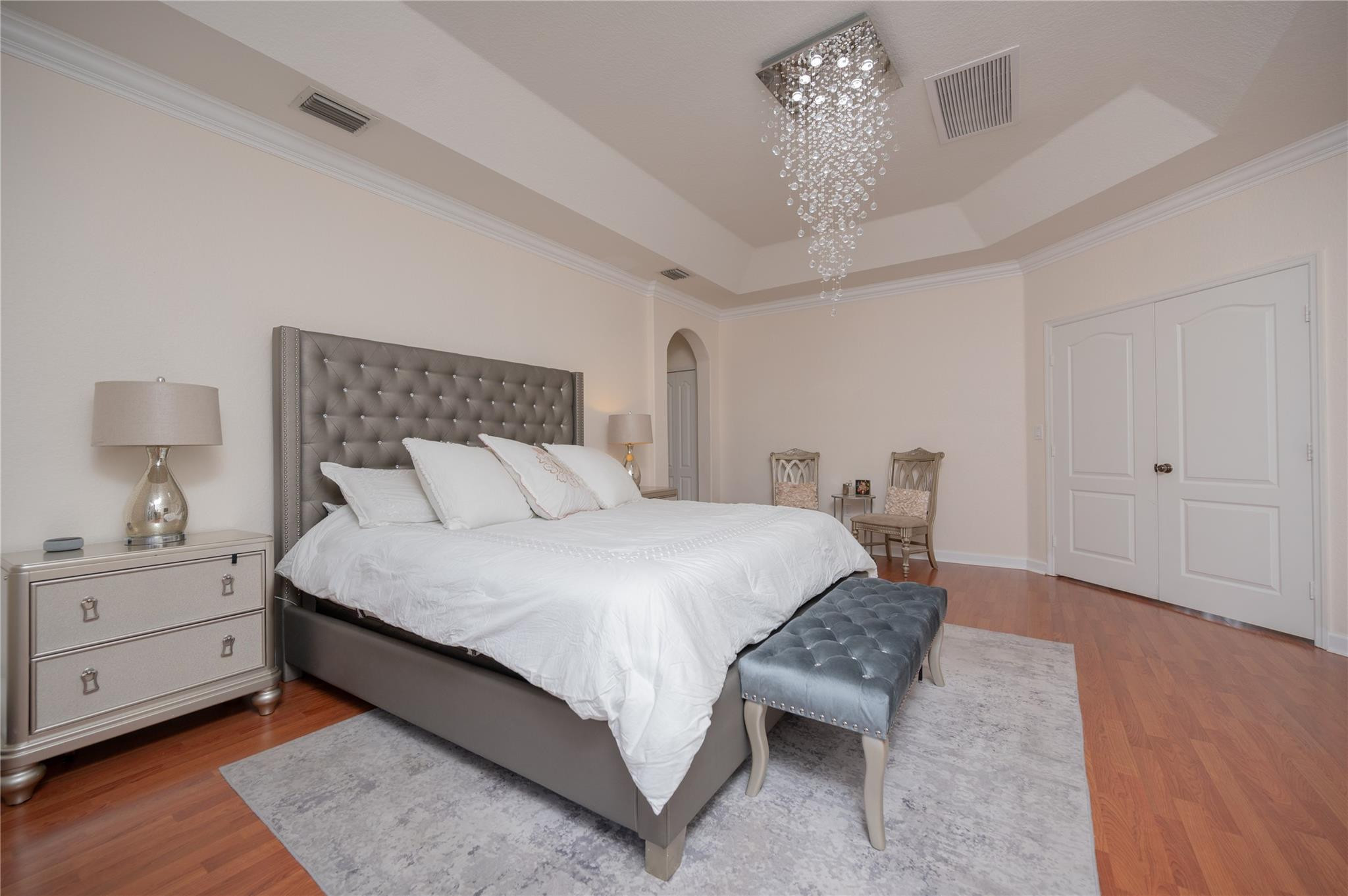 8891 Northwest 178th Lane Hialeah, FL 33018 - Photo 22 of 42 a bed room with a bed and a chandelier