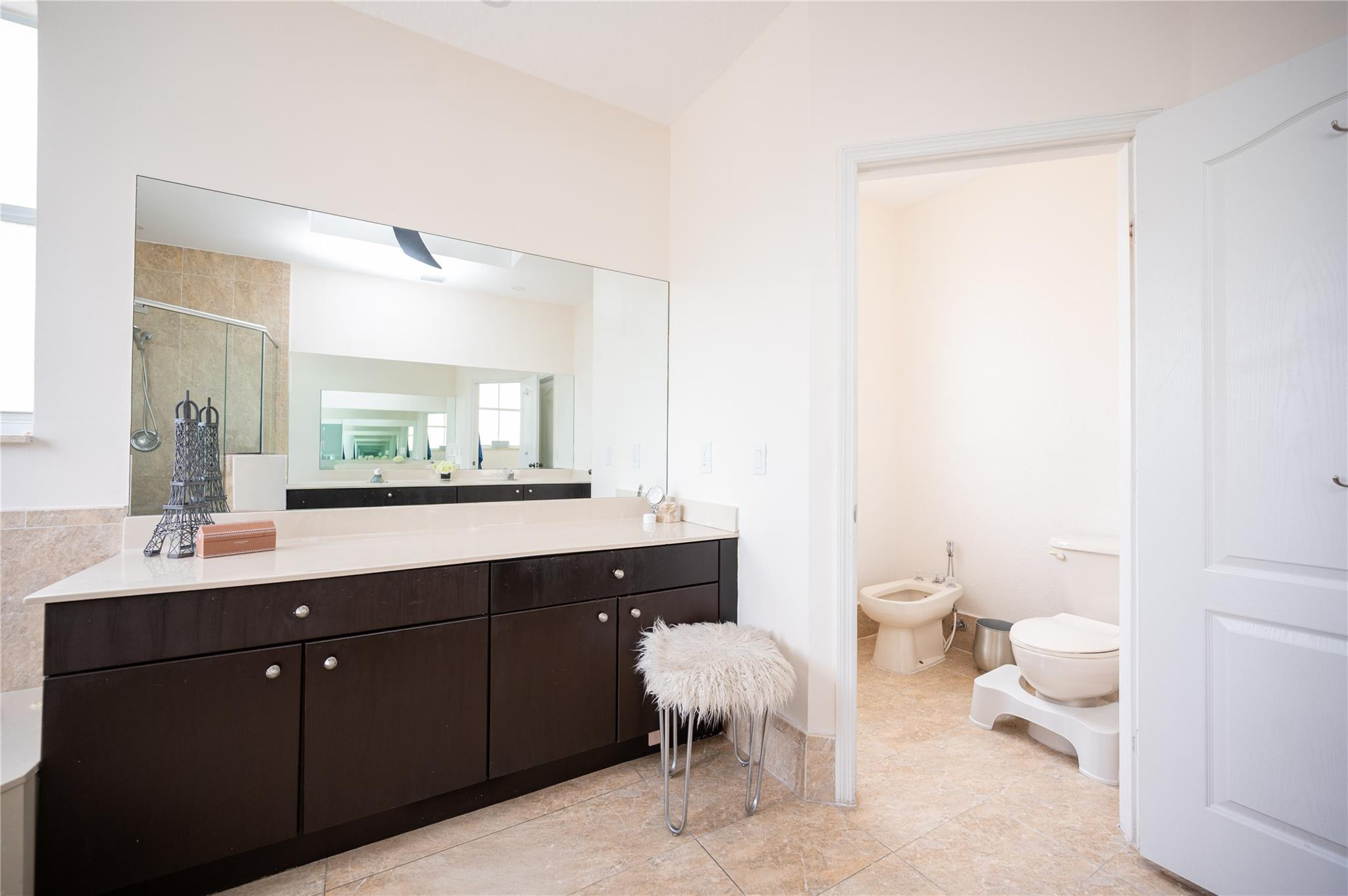 8891 Northwest 178th Lane Hialeah, FL 33018 - Photo 25 of 42 a spacious bathroom with a double vanity sink toilet and a tub