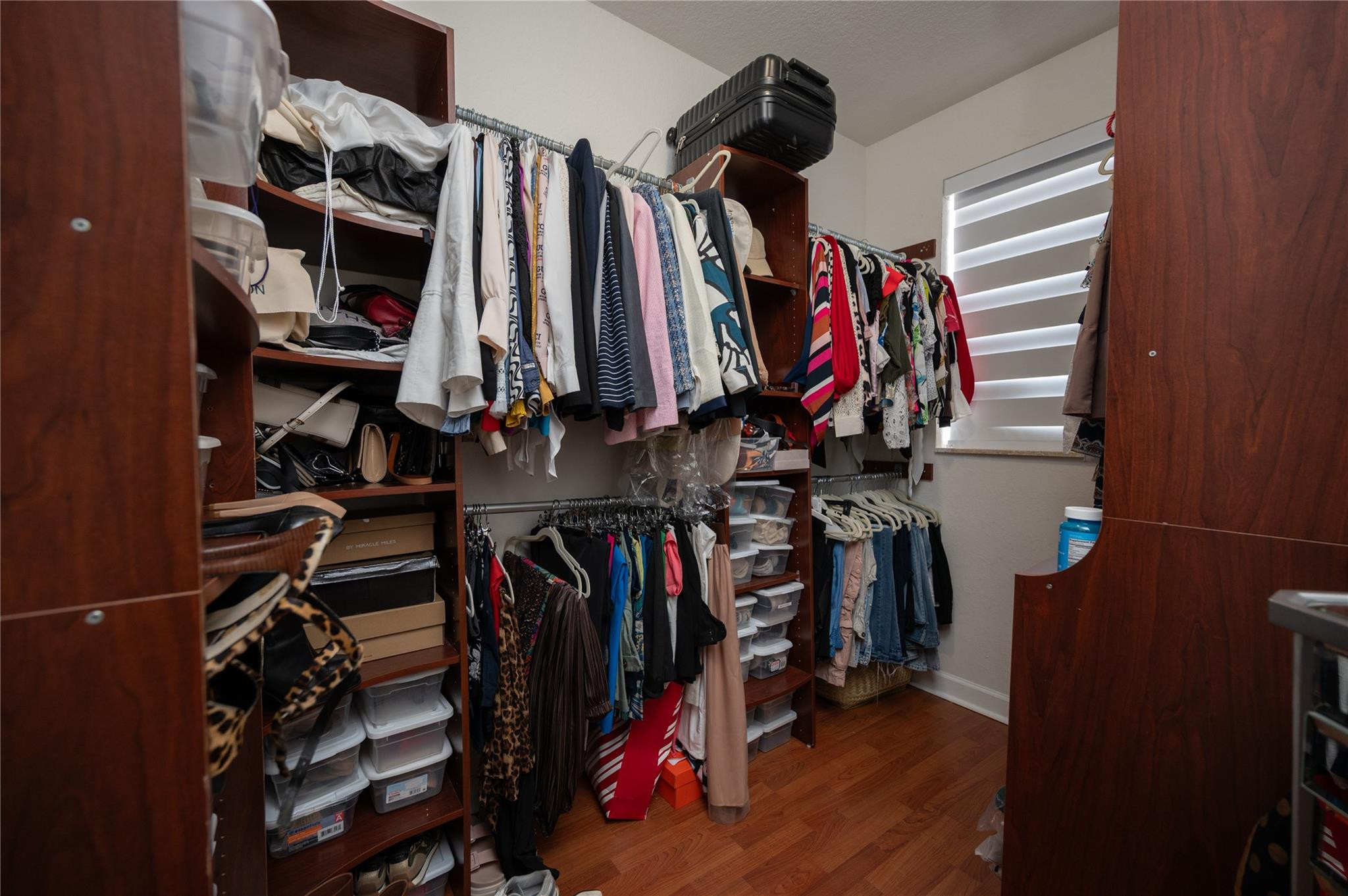 8891 Northwest 178th Lane Hialeah, FL 33018 - Photo 26 of 42 a view of walk in closet with clothes and shoes
