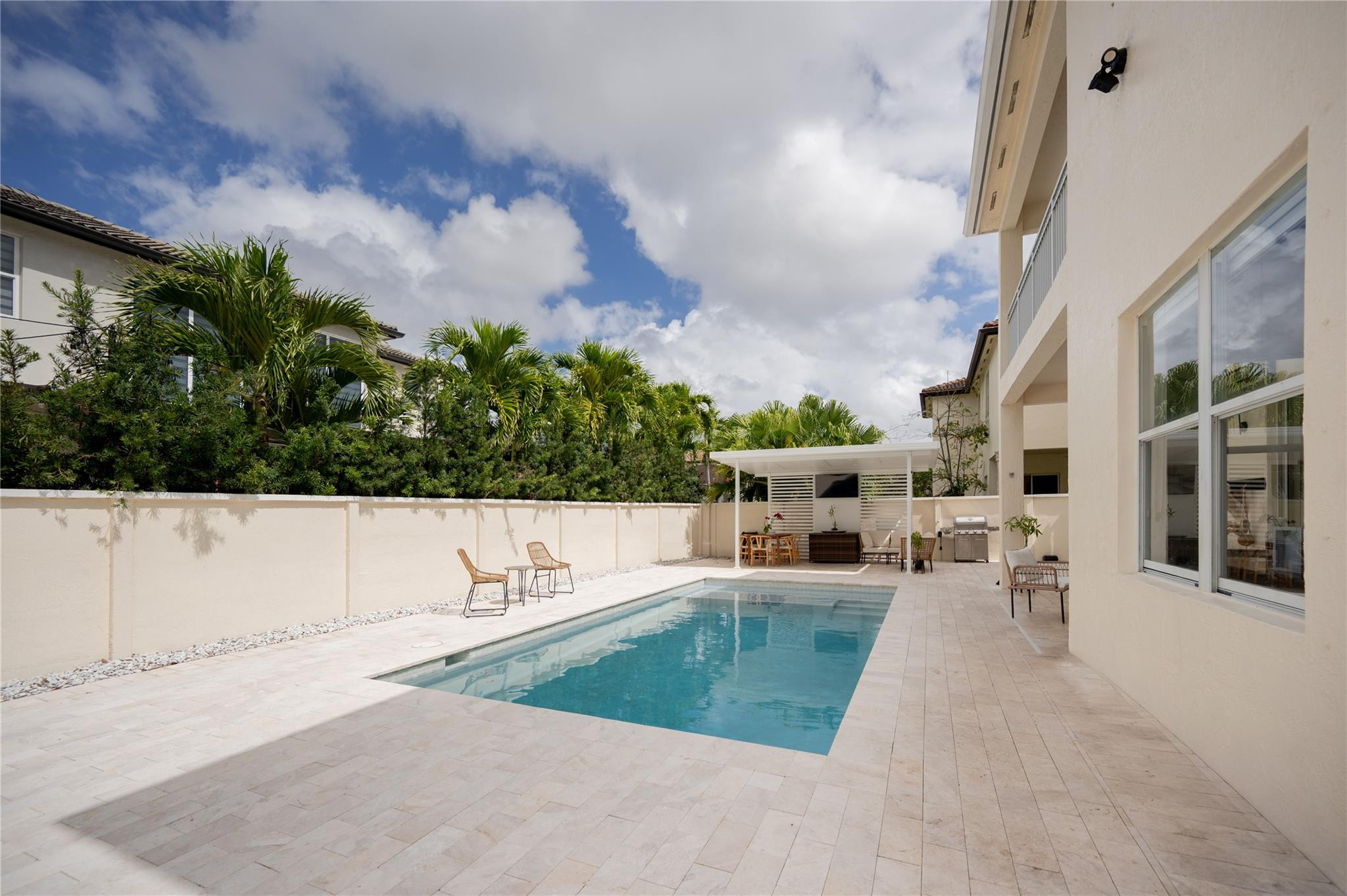 8891 Northwest 178th Lane Hialeah, FL 33018 - Photo 37 of 42 a view of a swimming pool with an outdoor seating and a yard
